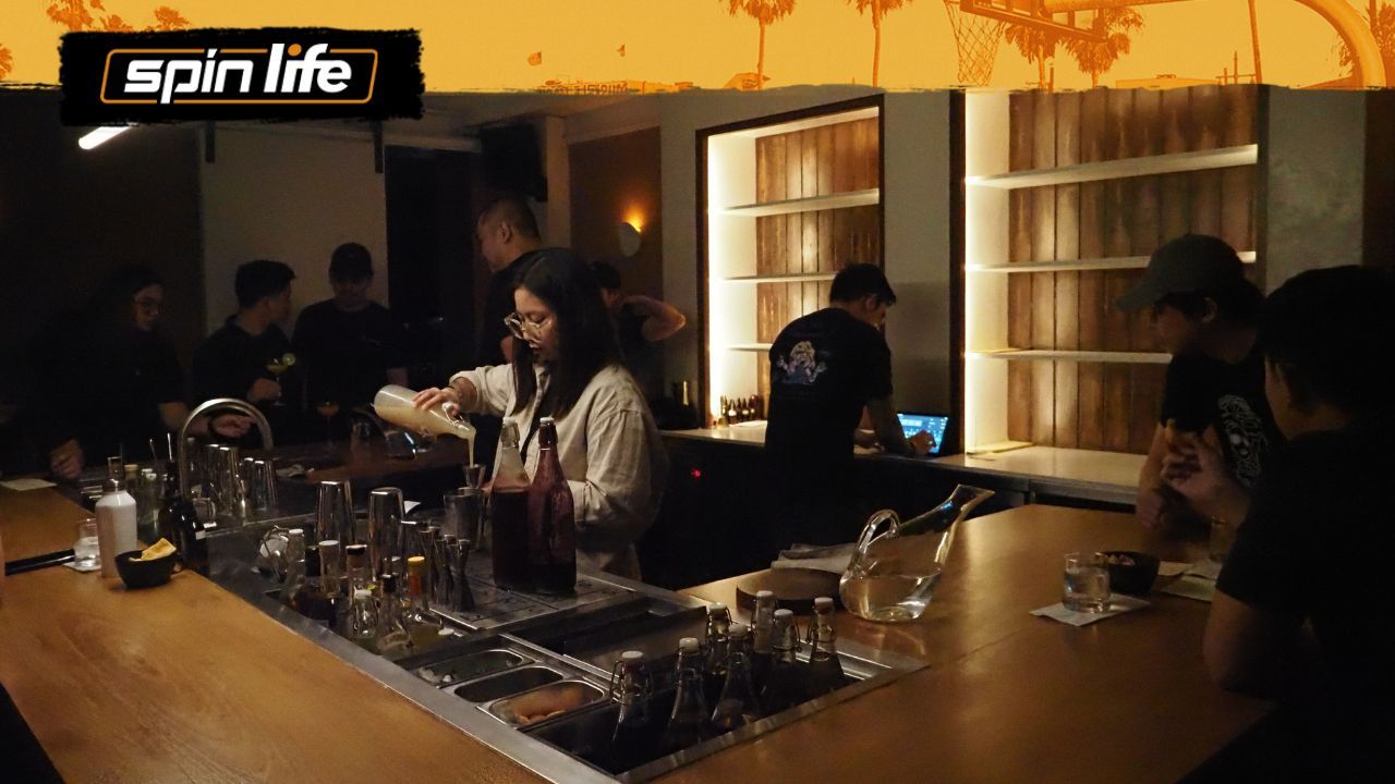 blank_space bar interior with bartender mixing drinks at the sunken bar counter